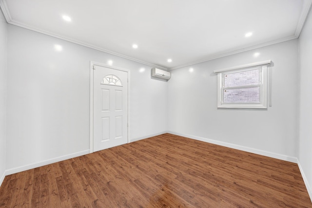 basement featuring a wall unit AC, crown molding, and wood-type flooring