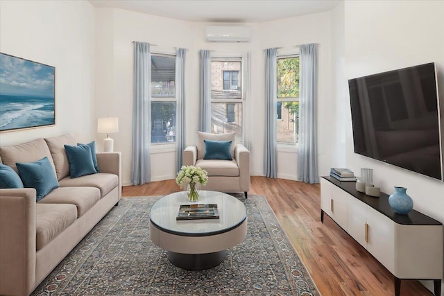 living room featuring dark hardwood / wood-style flooring and a wall unit AC