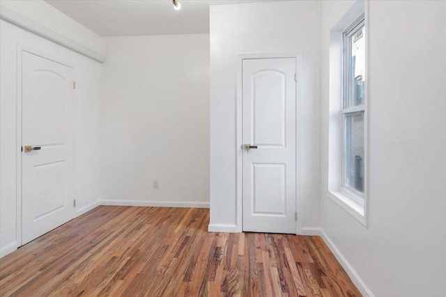 unfurnished room with dark hardwood / wood-style floors