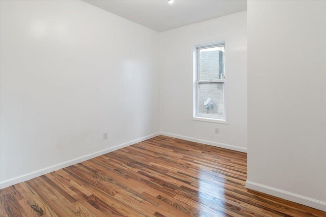 spare room with dark hardwood / wood-style flooring