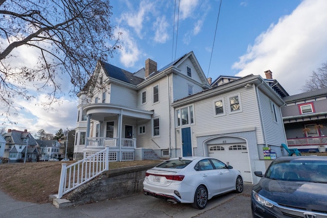 view of front of property with a porch and a garage