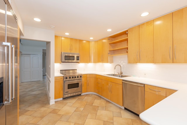 kitchen featuring appliances with stainless steel finishes, light brown cabinetry, and sink