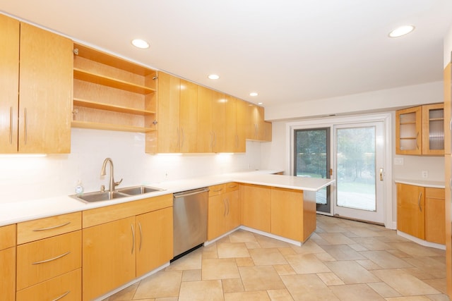 kitchen featuring dishwasher, kitchen peninsula, and sink