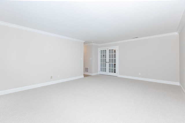 carpeted empty room with ornamental molding and french doors