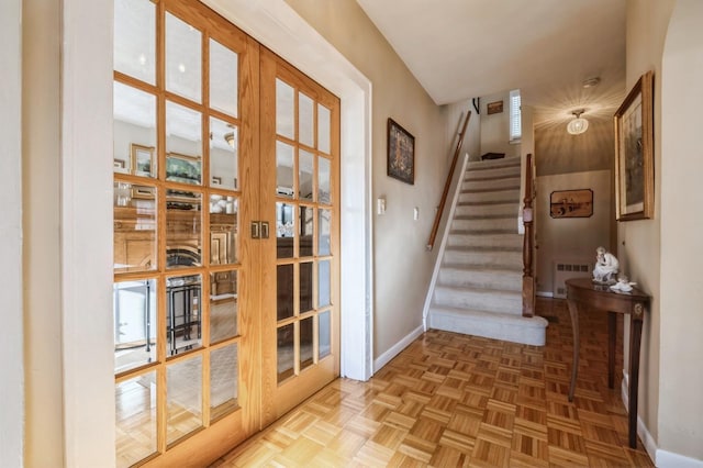 doorway to outside featuring french doors, radiator heating unit, and parquet floors