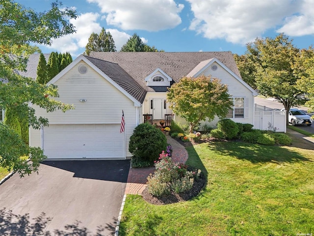 view of front of house with a garage and a front lawn