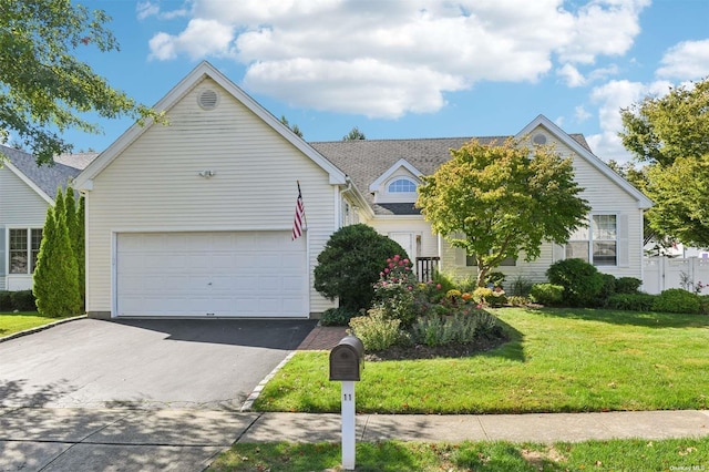 view of front of property featuring a garage and a front yard