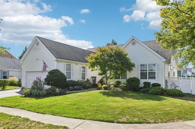 view of front facade with a garage and a front lawn