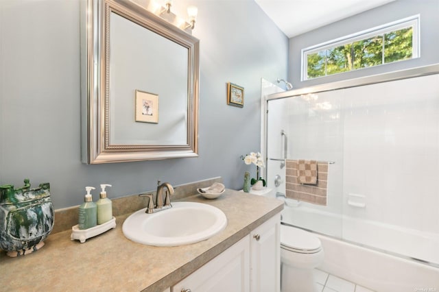 full bathroom featuring tile patterned flooring, vanity, toilet, and bath / shower combo with glass door