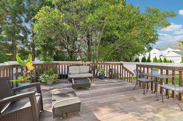 wooden deck with an outdoor living space