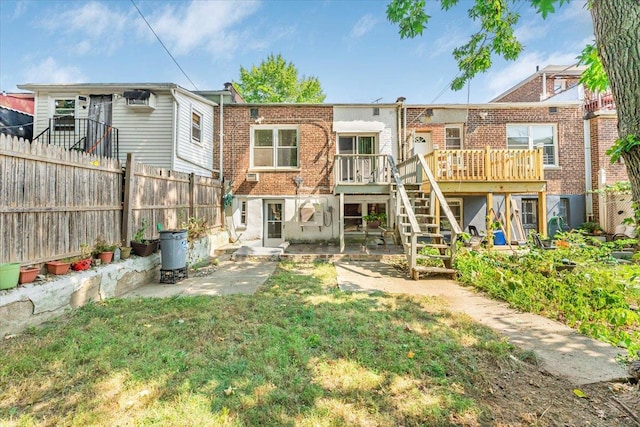 back of house featuring a yard and a wooden deck