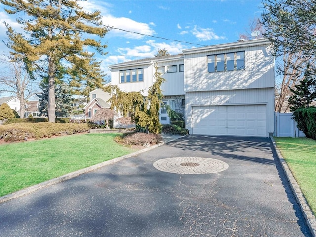 view of front of property with a front yard and a garage