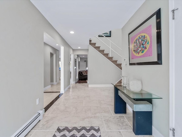 hallway with baseboard heating and tile patterned floors