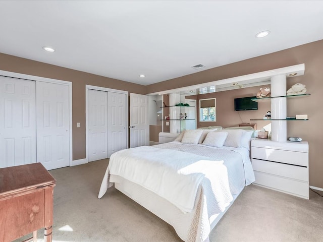 carpeted bedroom with multiple closets