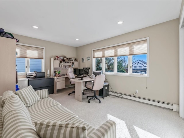 office area featuring light carpet and a baseboard heating unit