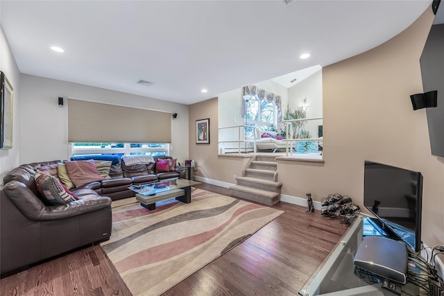 living room with wood-type flooring and vaulted ceiling