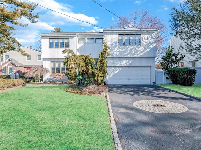 view of front of property with a garage and a front lawn