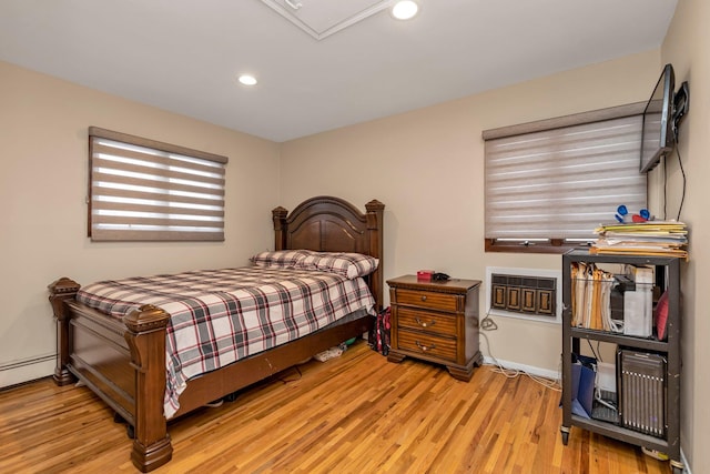 bedroom featuring light hardwood / wood-style floors and a baseboard radiator