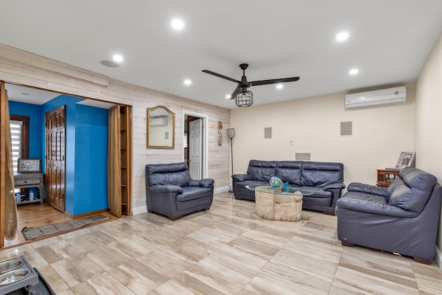 living room with an AC wall unit and ceiling fan