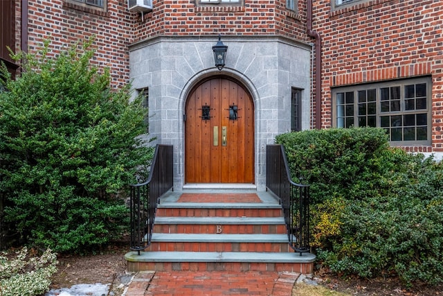 view of exterior entry with brick siding