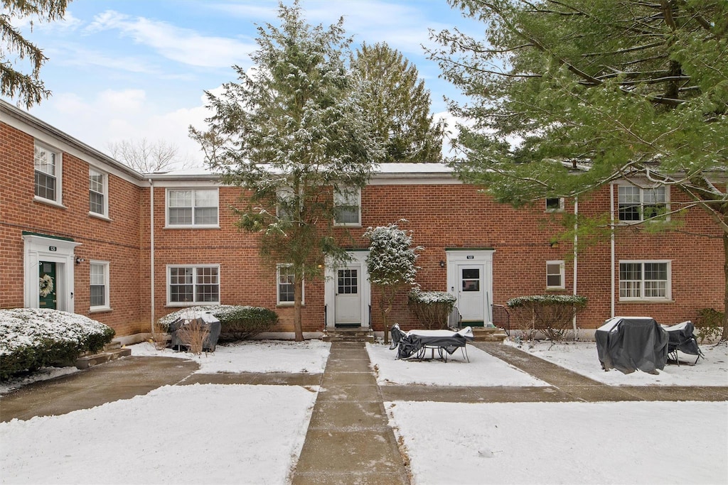 view of snow covered back of property