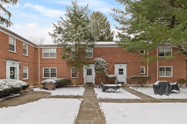 view of snow covered back of property