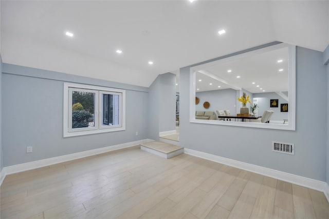 living room with lofted ceiling and light wood-type flooring