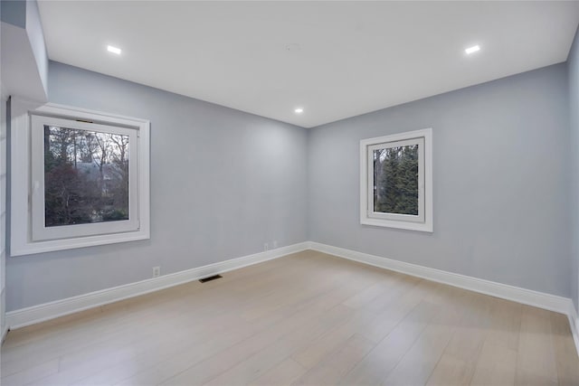 unfurnished room with light hardwood / wood-style flooring