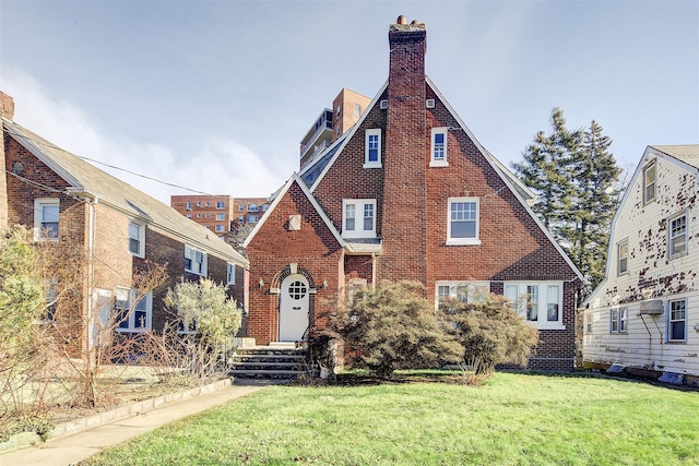 tudor house featuring a front yard