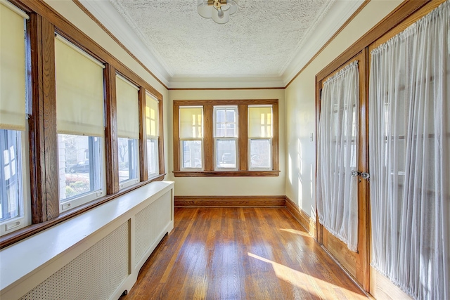 unfurnished sunroom with radiator