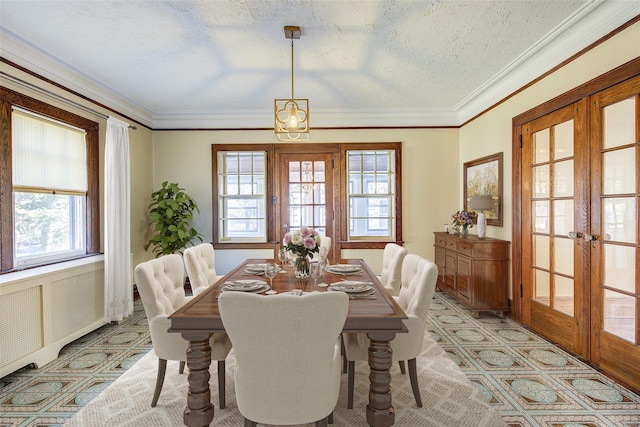 dining space featuring crown molding, french doors, and a textured ceiling