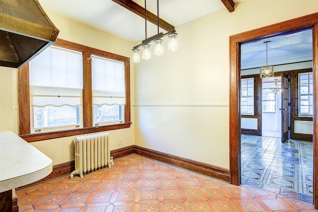 unfurnished dining area with beamed ceiling and radiator