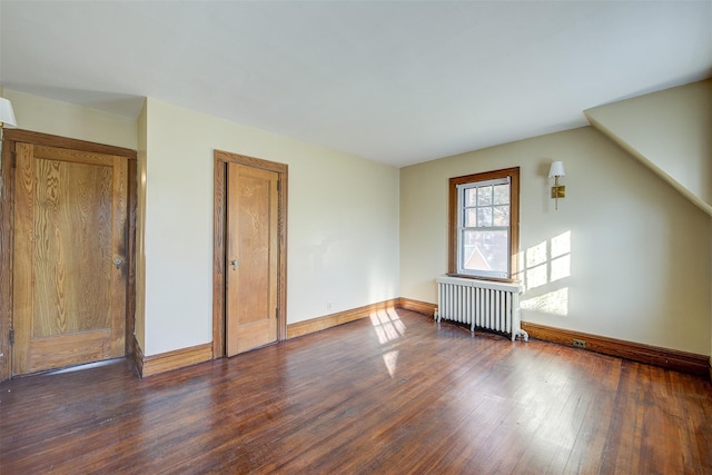 interior space with dark hardwood / wood-style floors and radiator heating unit