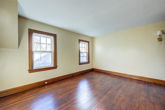 unfurnished room with dark hardwood / wood-style floors