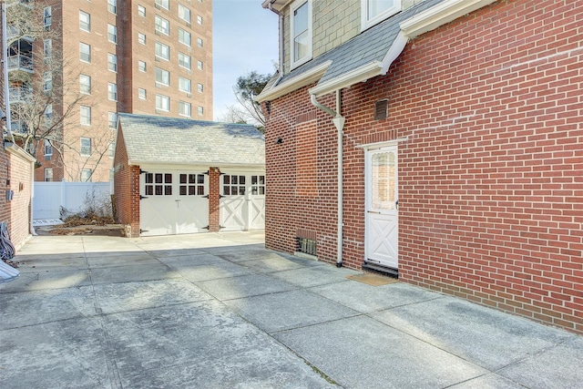 view of home's exterior with a garage and an outdoor structure