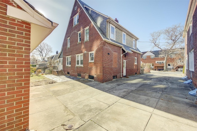 view of side of home with a patio area