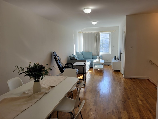 dining area featuring dark wood-type flooring