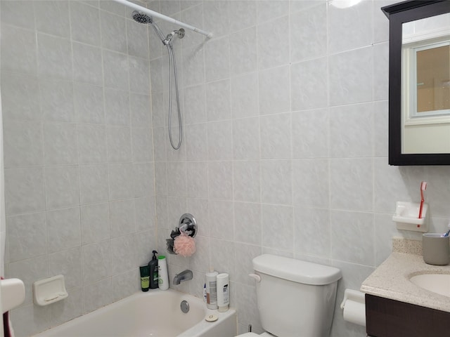 full bathroom with vanity, tiled shower / bath combo, and toilet