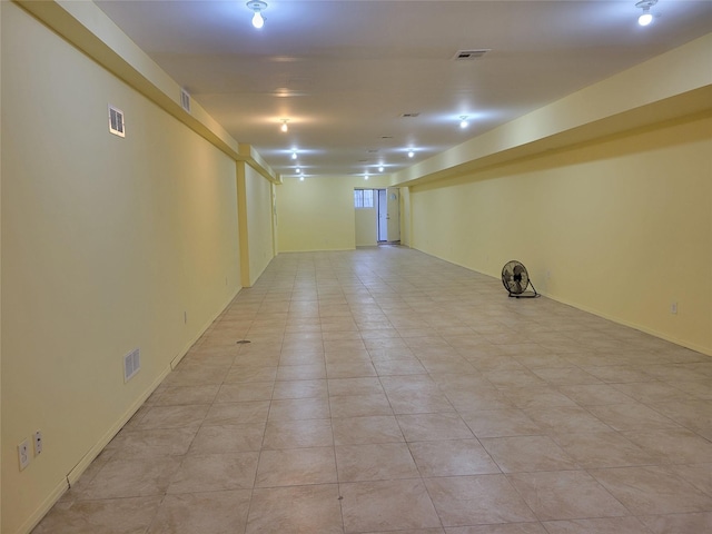 basement featuring light tile patterned flooring