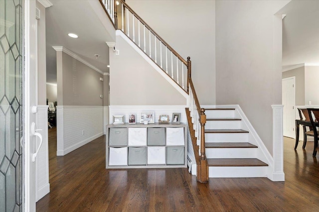 entryway with dark hardwood / wood-style floors and ornamental molding