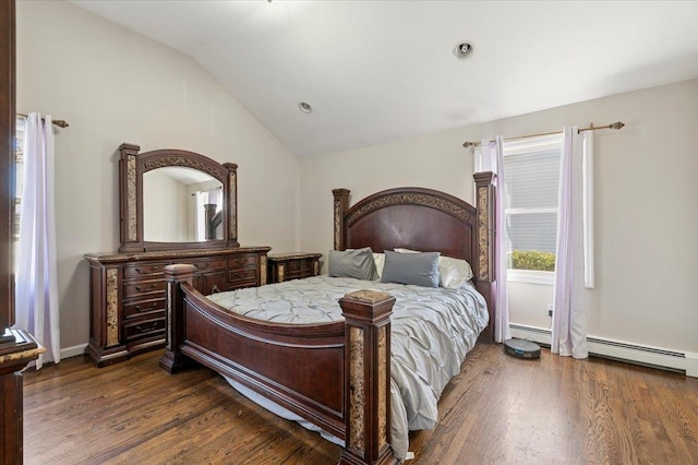 bedroom with a baseboard heating unit, lofted ceiling, and wood finished floors