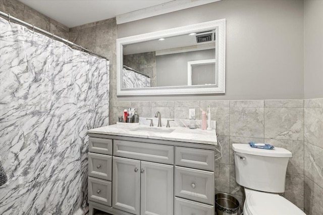 full bathroom featuring visible vents, toilet, a shower with shower curtain, tile walls, and vanity