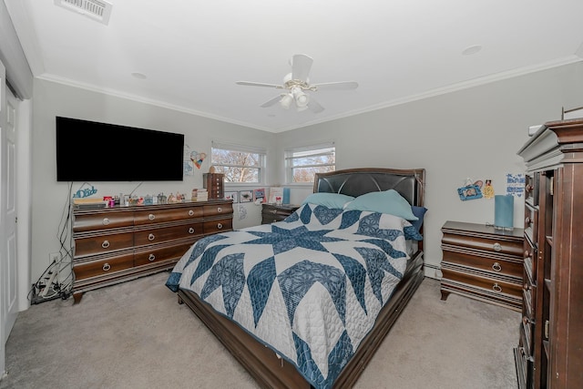 carpeted bedroom with ceiling fan, crown molding, and a closet