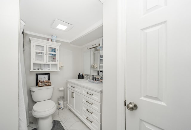 bathroom with toilet, crown molding, and vanity