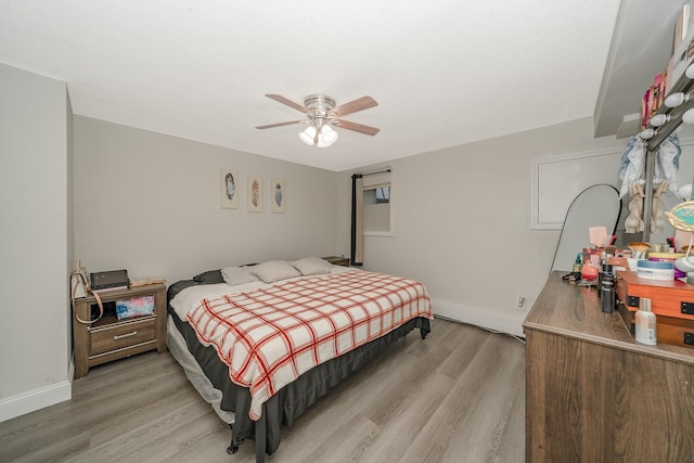 bedroom with light wood-type flooring and ceiling fan