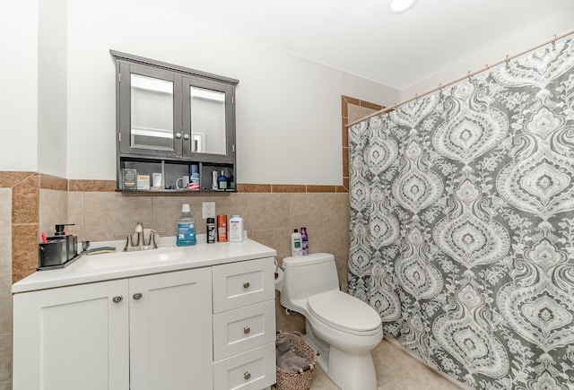 bathroom with toilet, tile patterned flooring, curtained shower, tile walls, and vanity