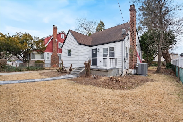 view of front of home featuring a front lawn and central AC unit