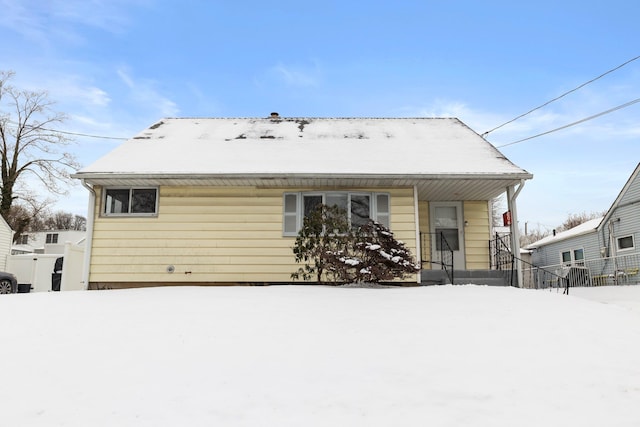 view of snow covered back of property