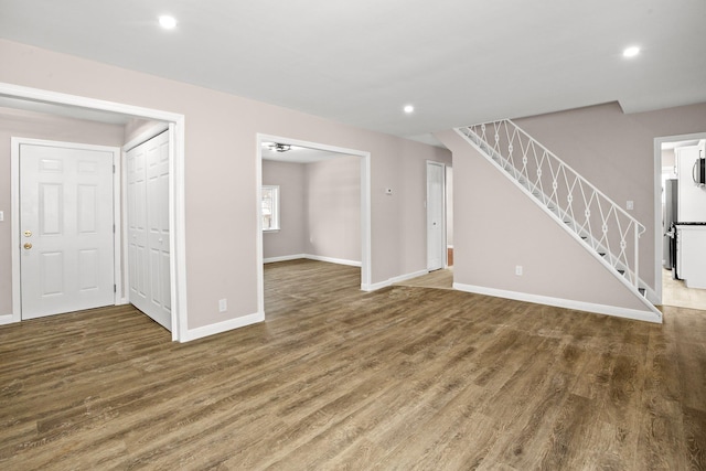 unfurnished living room with dark hardwood / wood-style flooring