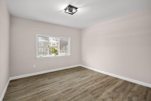 spare room featuring dark wood-type flooring